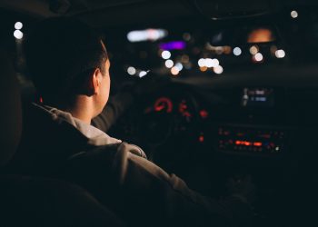 young man driving his car night time